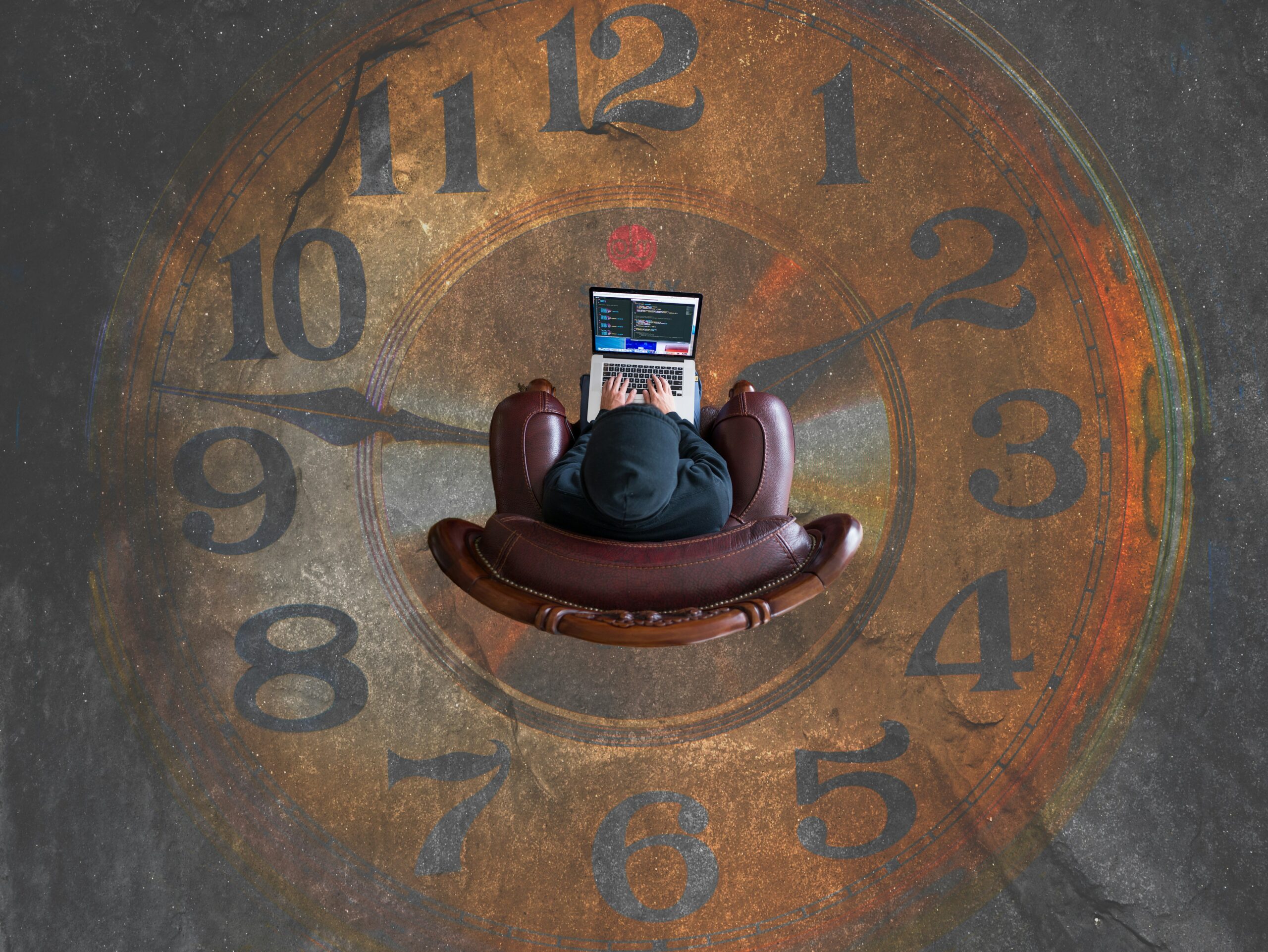 a person sitting in a chair with a laptop